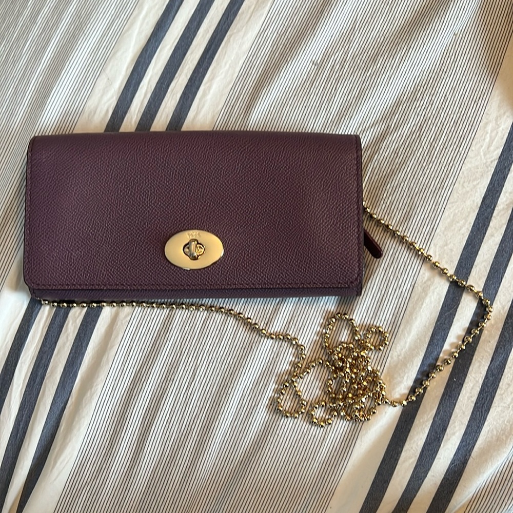Purple Coach wallet with attachable chain.